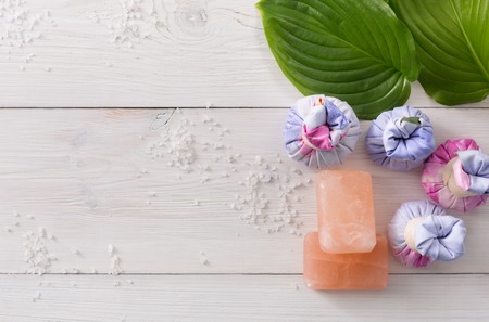Spa treatment and aromatherapy top view background with copy space on white wood. Aroma salt, soap, herbal balls for indian spaの写真素材