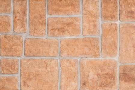 Red brick wall background. Modern wall with smooth decorative false bricks texture.