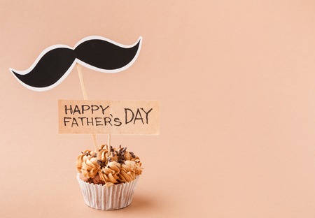 Fathers day background with copy space, cupcake and mustache with greeting cardの写真素材
