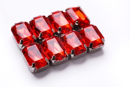 Ruby loose gemstones pattern on white background. Ornament of red mounted gems, jewelry production concept.の写真素材