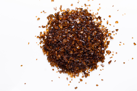 Heap of brown Amber stones on white background top view. Pile of natural gems, free space for text. Beauty, jewelry conceptの写真素材