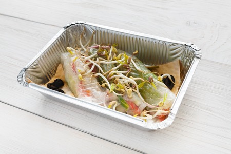 Healthy food delivery in foil closeup. Restaurant dishes, lunch for dietの写真素材