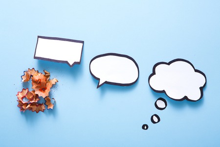 Creative ideas concept. Blank speech bubbles handcrafted on blue background, top view, copy space for textの写真素材