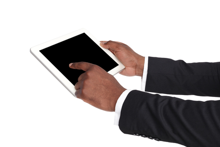 Holding and pointing to blank screen on digital tablet. African american businessman using device with blank screen, copy space for advertisement, isolated on white backgroundの写真素材