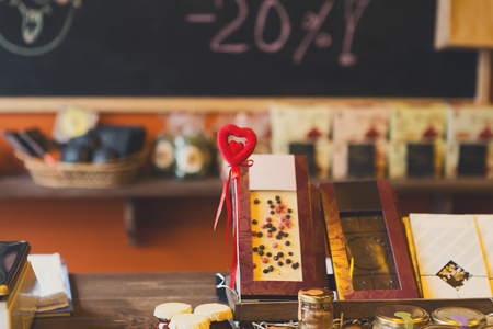 Variety of chocolates and marmalades at counter of a pastry shop. Valentine day at pastry shop. Candy shop interior illuminated by sunlihgt. Background, copy spaceの写真素材