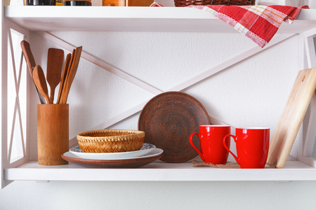 White wooden shelf - kitchen furniture in rustic style with utensils and bright decorative detailsの写真素材