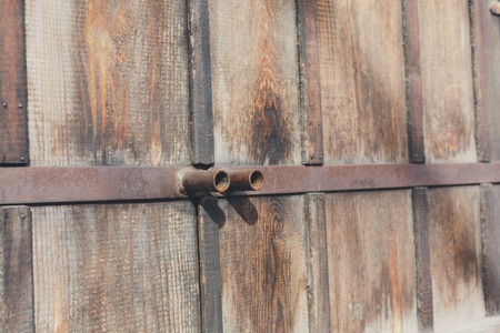 Natural wood doors with rusty metal handles. Wood texture and background. Rustic, old wooden surface.の写真素材
