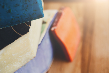 Cheese closeup. Gouda pesto lavender, blue, violet and red at cheese grocery backgroundの写真素材
