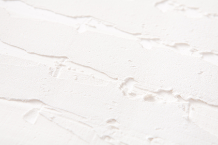 White wall with plaster pattern background. Textured backdrop, interior design conceptの写真素材