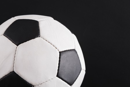 Soccer ball on black background. Playing football, active lifestyle conceptの写真素材
