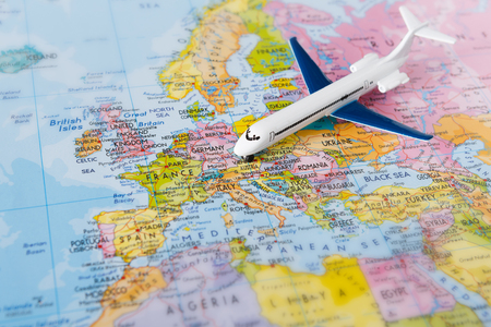 Travel to europe by plane background. Plane on map closeup. Vacation and business trip conconceptの写真素材