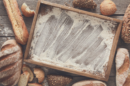 Bread bakery background, wooden tray top view with copy space