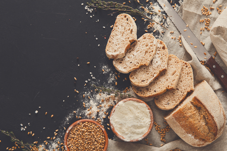 Bakery background, bread on black. Flour and grain with copy spaceの写真素材