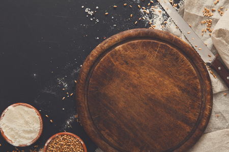 Baking background, flour on board at black. Bakery and home bread making concept. Copy spaceの写真素材