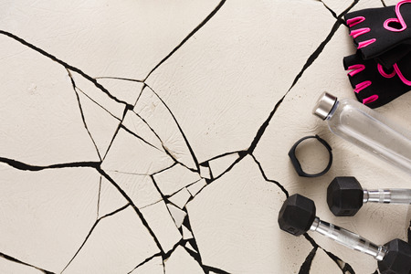 Female sport gloves and equipment top view, copy space. Set of new fitness wear for women, active lifestyle, body care conceptの写真素材