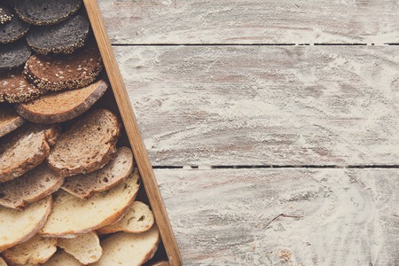 Bakery, bread gradient background on wood. Grocery concept with copy space. Black, rye and white...