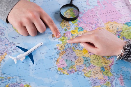 Young couple planning vacation trip with map to France, Europe. Top view.の写真素材
