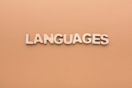 Word Language made of English letters on beige background, copy space. English language learning concept.の写真素材