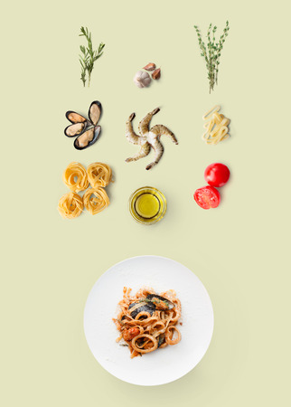 Cooking ingredients for italian food, seafood pasta, isolated on beige. Frutti di mare with fettuccine spaghetti. Mussels, prawn, shrimp, calamari rings and other ingredients around plate with dishの写真素材