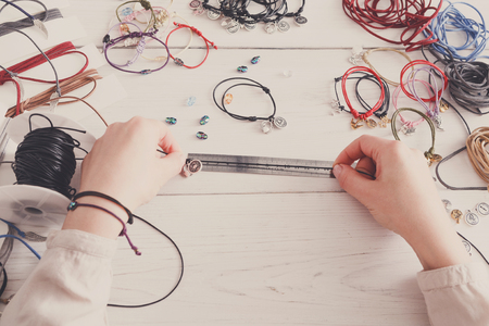 Handmade jewelry making, female hobby. Woman creating bracelet at home workshop, artisan pov. Fashion, handicraft conceptの写真素材