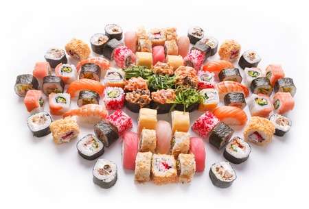 Japanese food restaurant delivery - tuna sushi maki, salmon rolls and spicy gunkans with seaweed big party platter set isolated on white backgroundの写真素材
