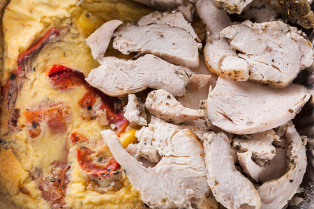 Healthy lunch in foil container. Healthy food take away and delivery. Slices of chicken, omelet with vegetables, closeupの写真素材