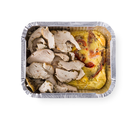 Healthy lunch in foil container. Healthy food take away and delivery. Omelet with vegetables, chicken in box on white background, closeup, isolated on whiteの写真素材