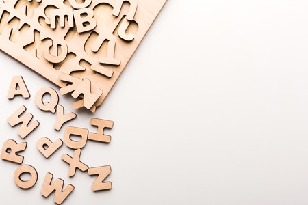 Wooden board with English alphabet letters. Sorter toy for child development and education.