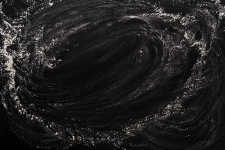 Flour on black, baking background with copy spaceの写真素材