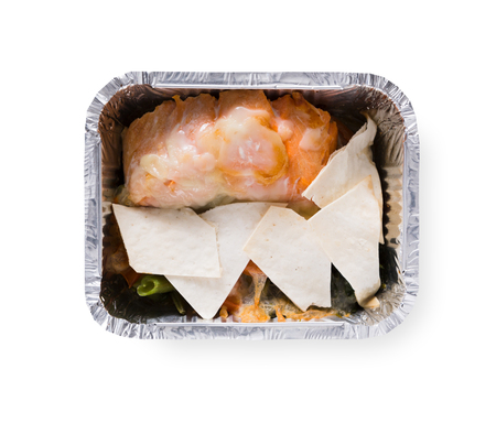 Healthy lunch in foil container. Healthy food take away and delivery. Vegetables, red fish and pita in box on white background, closeup, isolatedの写真素材
