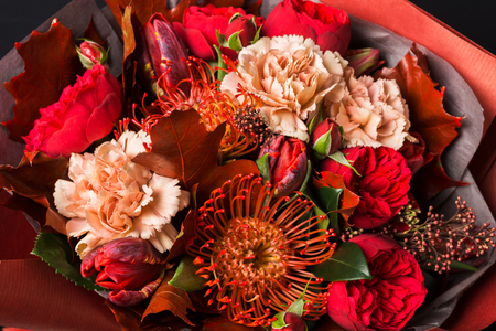 Beautiful flowers bouquet background. Flower shop composition at black closeup. Florist art and floral design conceptの写真素材