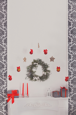 Christmas decorations above white fireplace. Winter holiday design, garland and ornaments backgroundの写真素材