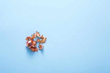 Art and education, creativity background. Color pencil shavings on blue, flat lay, copy space, top...