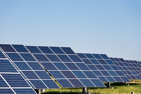 Solar panels energy farm on sky background. Photovoltaic modules producing clean electric power. Alternative energy systems and environmental problems concept, copy spaceの写真素材
