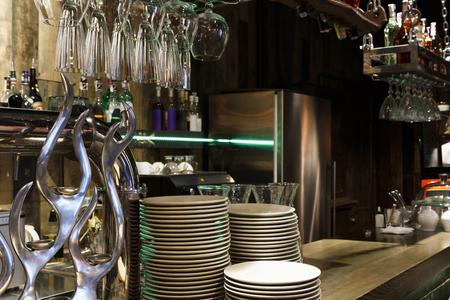 Bar counter with clean dishes close up. Barroom in restaurant, ready for work, copy space. Cafe backgroundの写真素材