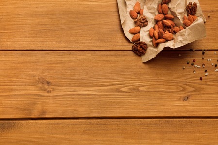 Nuts on rustic wood background. Healthy natural food on table with copy space.の写真素材
