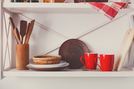 White wooden shelf - kitchen furniture in rustic style with utensils and bright decorative detailsの写真素材