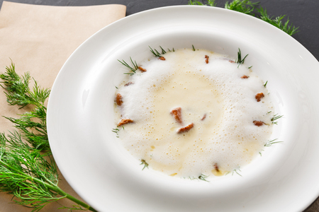 Delicious cream soup with honey fungus close up. Gourmet meal with mushrooms, restaurant servingの写真素材