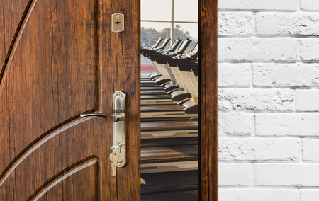 Opened door to gym interior with equipment. Entrance to fitness club with row of treadmills for fitness cardio training. Welcome to sport, healthy lifestyle conceptの写真素材