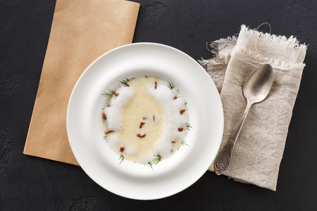 Delicious cream soup with honey fungus top view. Gourmet meal with mushrooms and crusty bread, restaurant servingの写真素材
