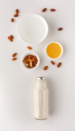 Healthy food. Almond milk with ingredients on white background, top view, copy space.の写真素材