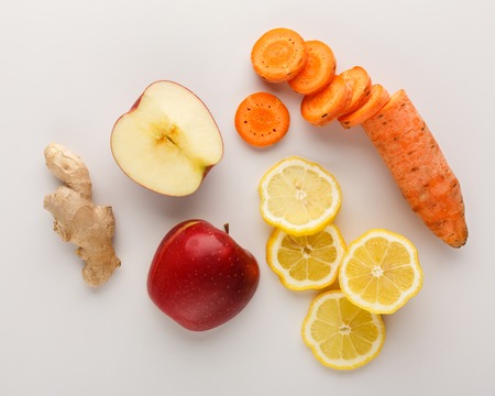 Healthy food. Ingredients for detox smoothie, ginger, carrot, apple, lemon on white background, top view, copy space.の写真素材