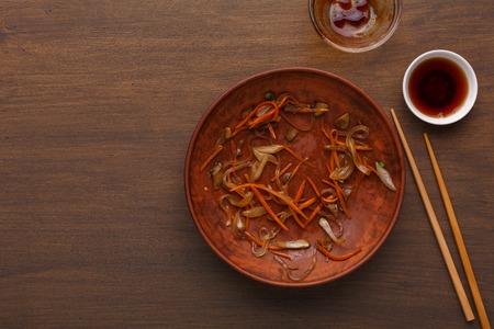 Empty plate after dinner, leaving only the crumbs on wooden background. Asian cuisine concept, top viewの写真素材