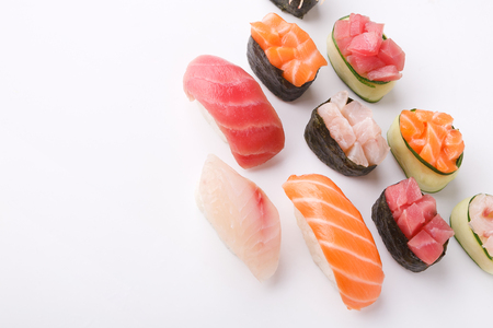 Set of sushi and maki isolated at white background. Salmon, tuna and seebas nigiri. Asian healthy restaurant food deliveryの写真素材