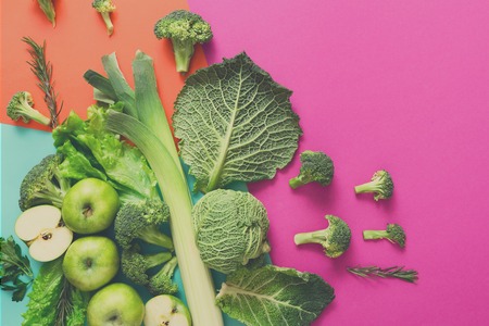 Green vegetables and fruits on bright background. Diet, detox and healthy food concept - top view flat lay of ingredients for salad, copy spaceの写真素材