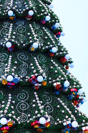 Decorated christmas tree outdoors, sparkling garland and lights, copy spaceの写真素材