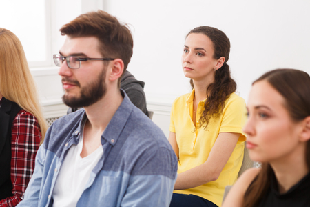 Group of people sitting at seminar, copy space. Serious and concentrated audience listening to speaker. Education, conference, workshop conceptの写真素材