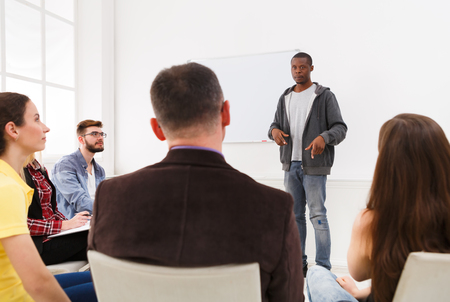 African-american man doing presentation in office, copy space. Startup business meeting, sharing new ideas to partners, teamwork conceptの写真素材