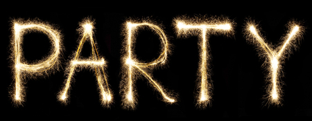 Party text written with sparkler letters isolated on black background. Christmas light. Shiny festive party firework font.の写真素材