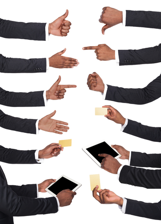 Set of black businessman hands holding tablet, card, showing symbols and gestures. Like, dislike, pointing with index finger. Isolated on white backgroundの写真素材